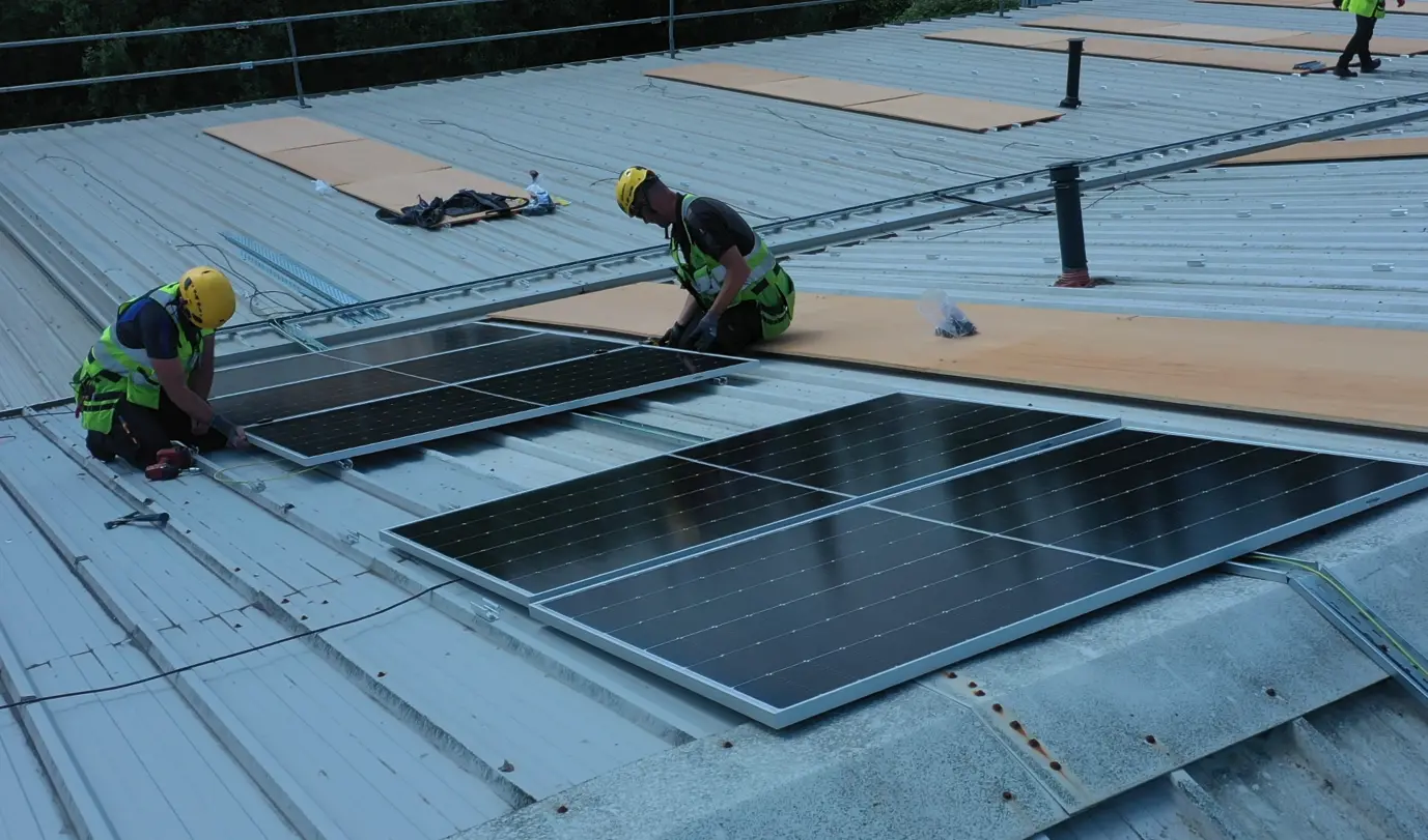 Solgrid Solar PV installers on the roof of Kean's Claremorris during the installation Solgrid Solar PV installers on the roof of Kean's Claremorris during the installation