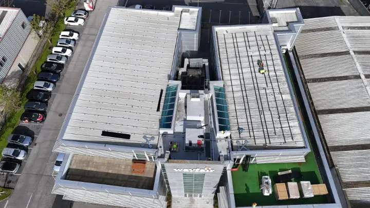 commercial solar panels drone shot of installers on roof