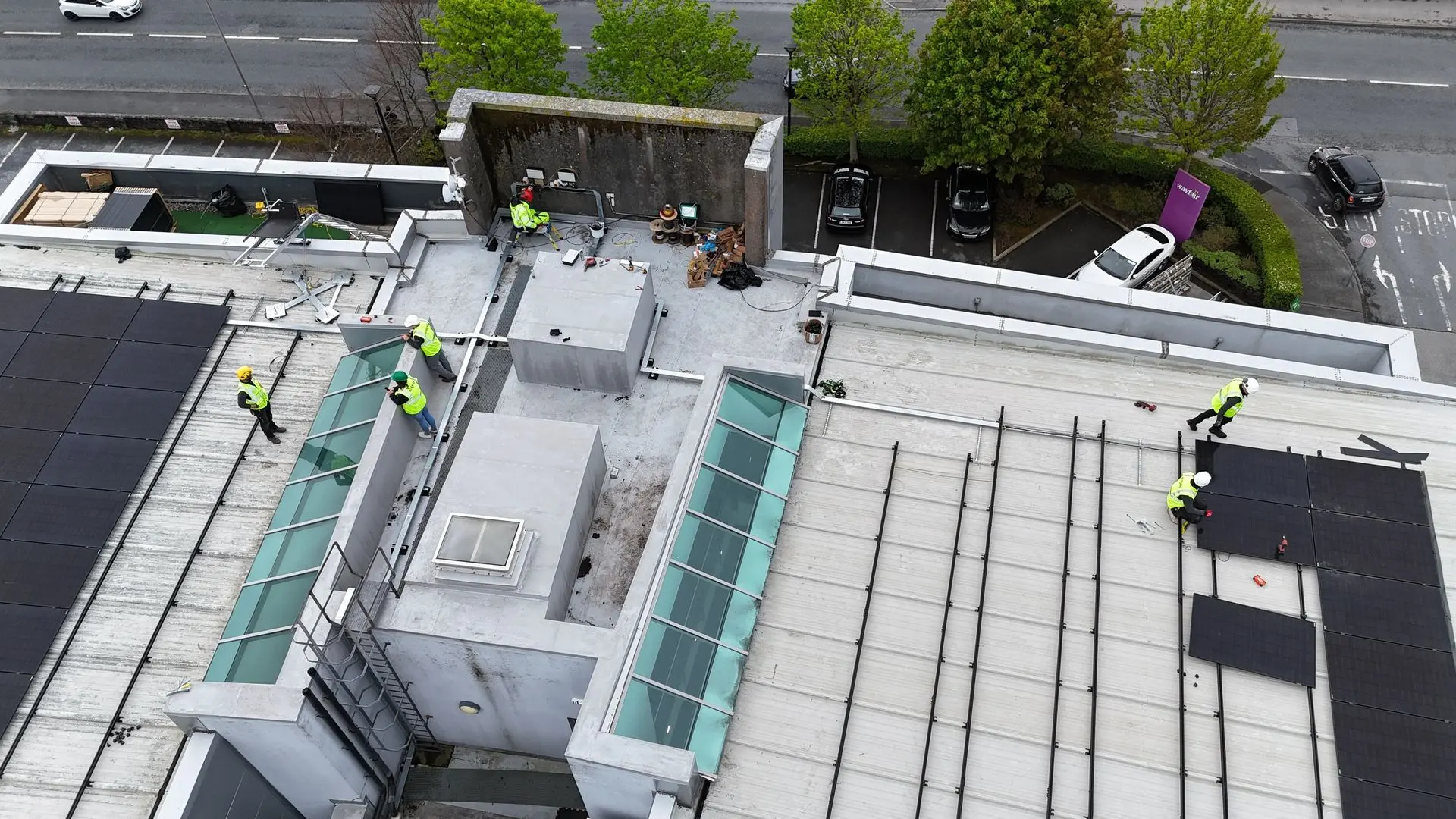 commercial solar panels drone shot of installers on roof
