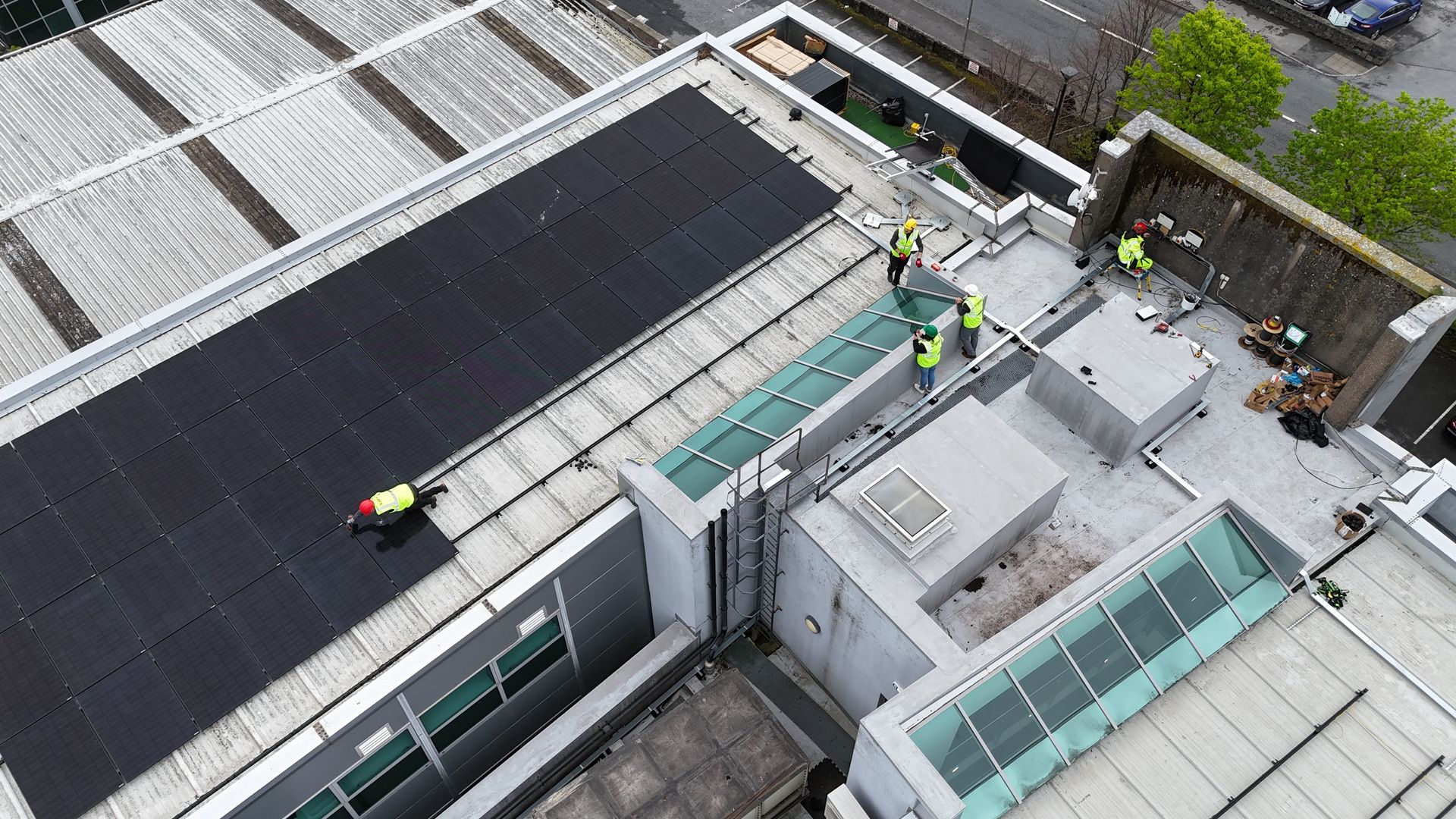 solar panel installers on roof of building in Galway